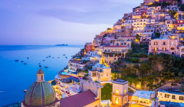 Summer sunset with view of town and seaside of Positano, Amalfi Coast, Campania, Sorrento, Italy