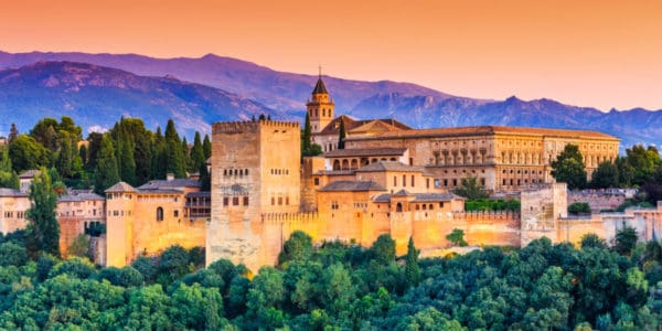 The Alhambra in Granada Spain during sunset with mountains in the background