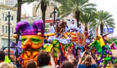 Mardi Gras parades through the streets of New Orleans with people cheering