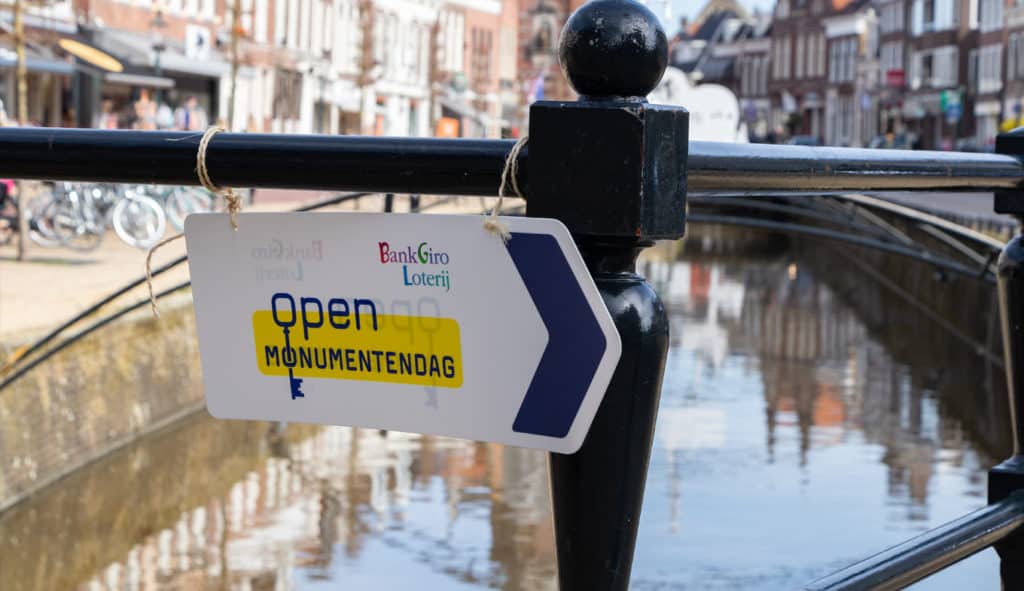 Sign during Open Monumentendag, Heritage Day, with view of a canal