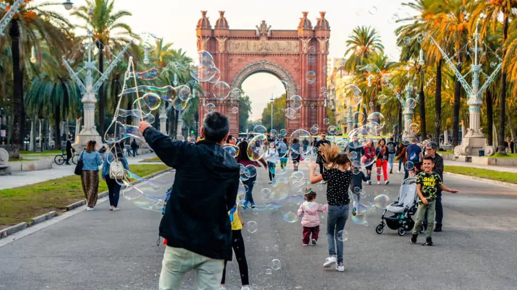 Man making bubbles for kids in parc de la ciutadella in Barcelona Catalonia Spain