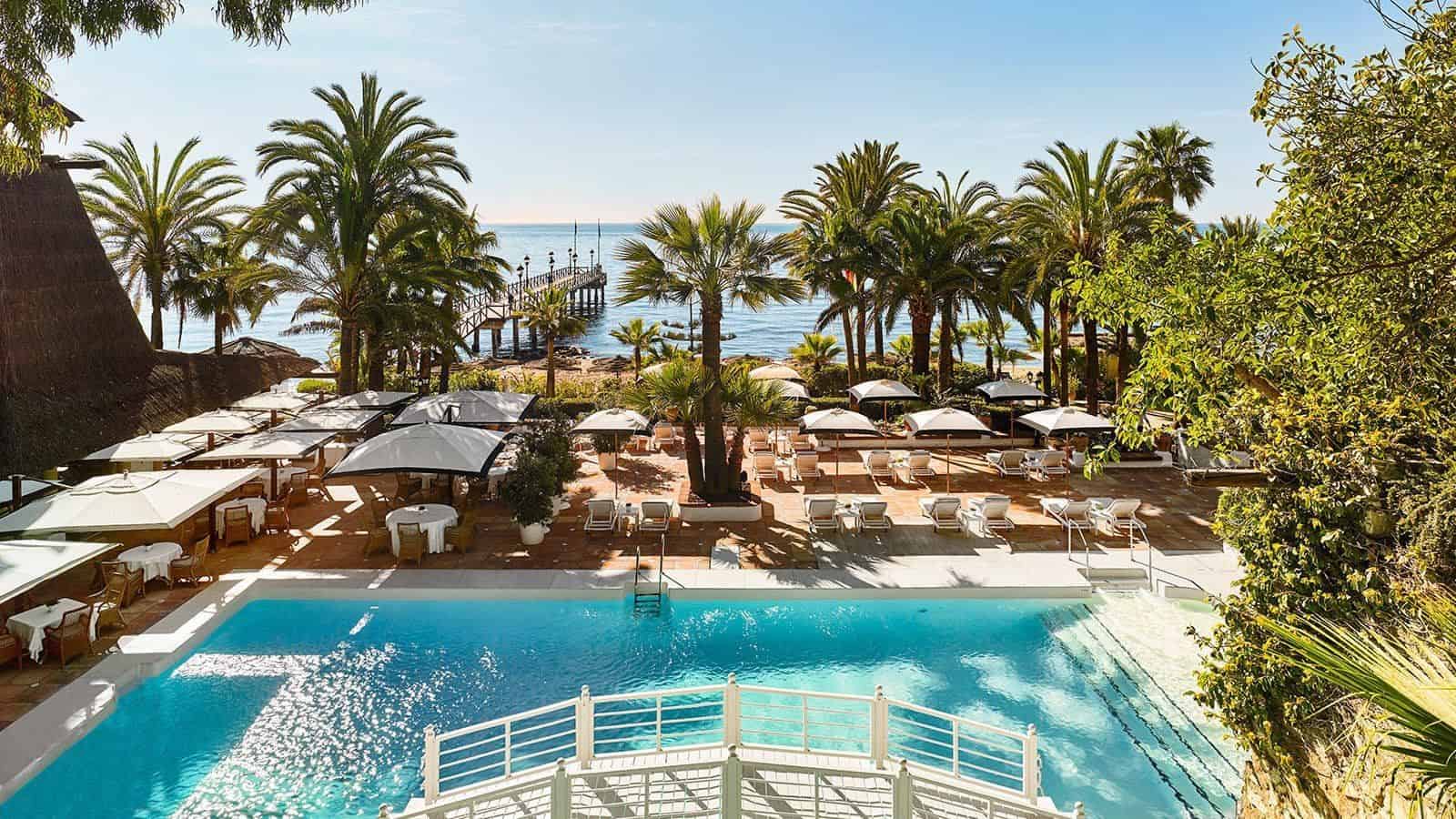Hotel pool view with palm trees at Marbella Club Hotel in Andalucia Spain