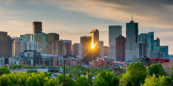 Sunrise peeks through the skyline of Denver