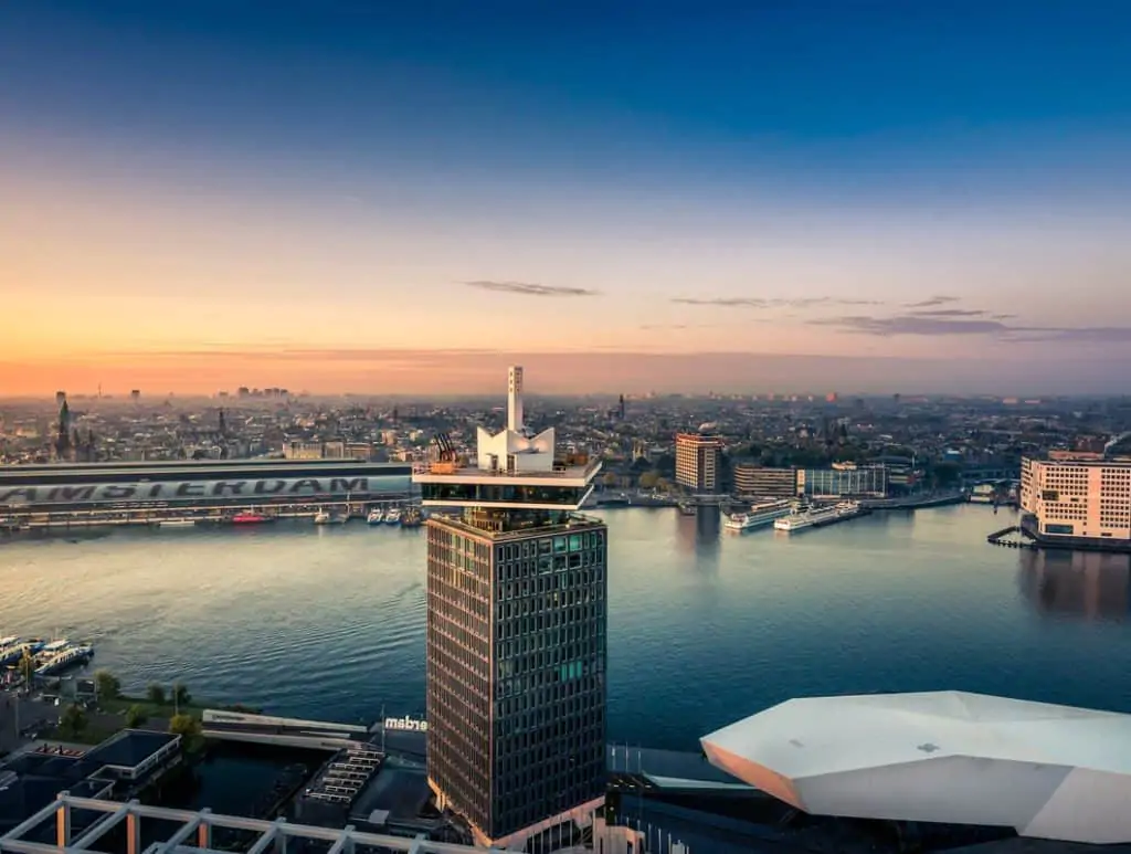 Birds eye view of the tower of Sir Adam Hotel Amsterdam with Centraal Station in background