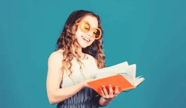 Happy kids reading an orange summer book