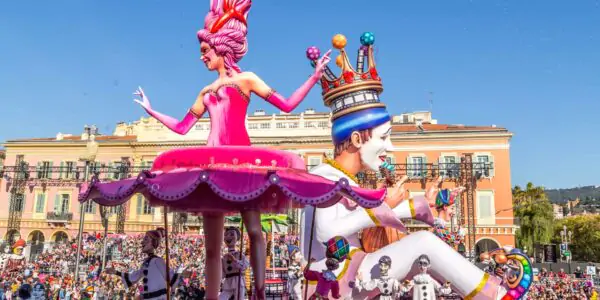 King of the Carnaval moves past the dancing ballerina at Carnaval de Nice, France